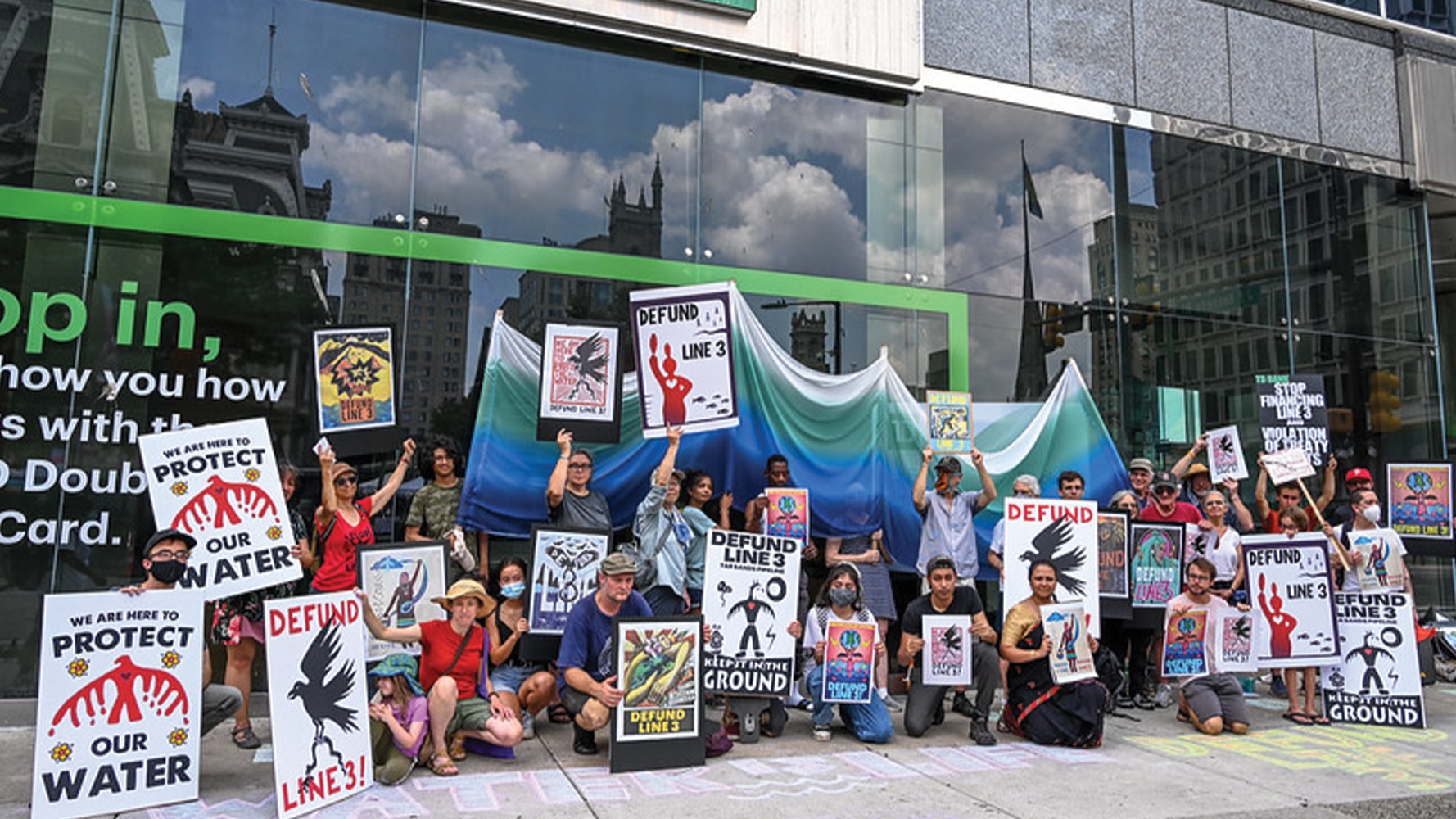 Activists participating in #DefundLine3 wheatpasting action in Philadelphia, PA.