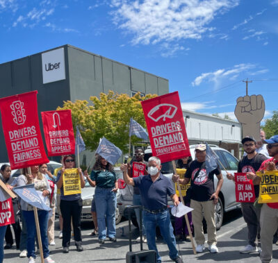 Drivers stand in front of Uber headquarters and demand fair pay