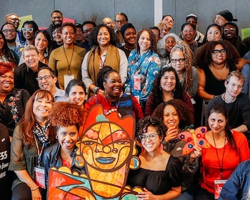 A group of Thriving Cultures grantees gather for a photo