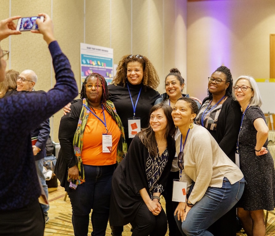 A group of people smile and pose for a photo together.